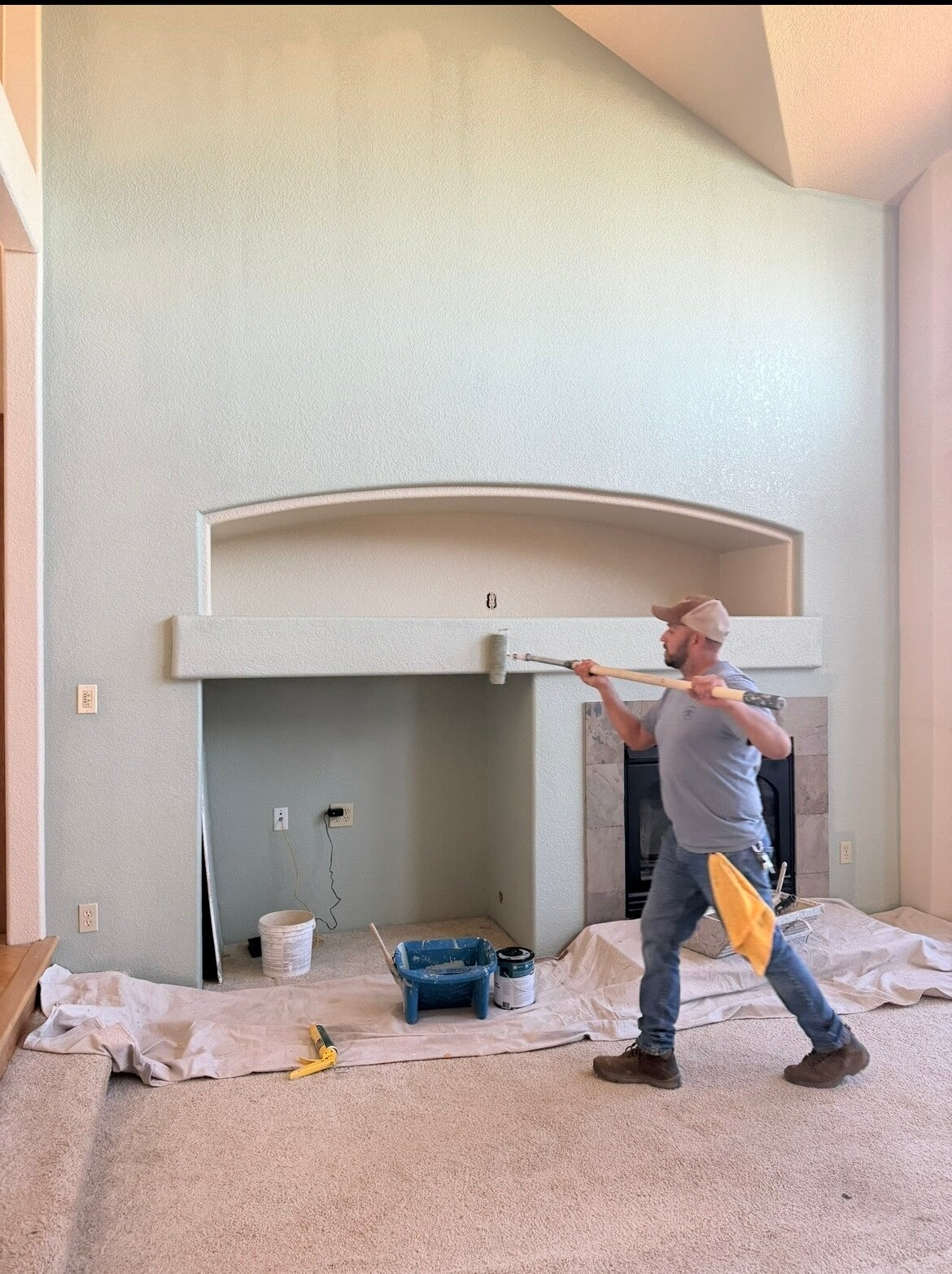 Interior repaint around a fireplace and mantel