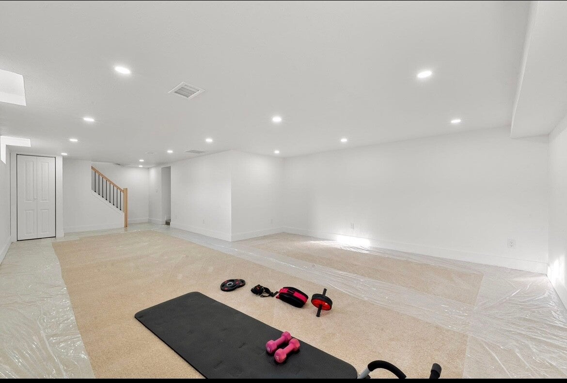 Newly finished basement with recessed lighting